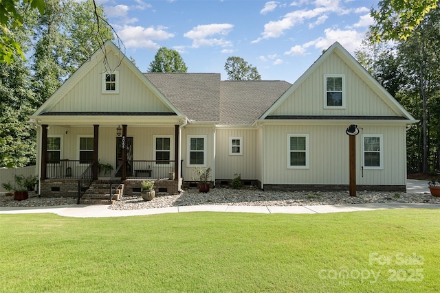 rear view of house with a porch, crawl space, roof with shingles, and a yard