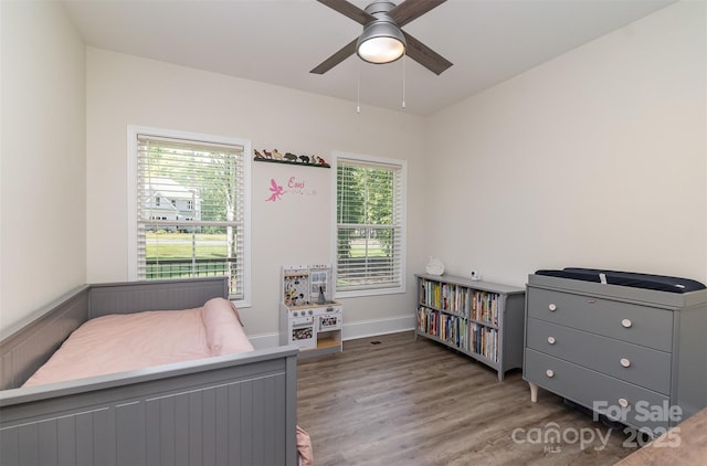 bedroom featuring dark wood-type flooring, a ceiling fan, and baseboards