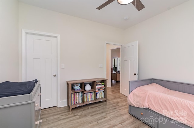 bedroom with a ceiling fan and light wood-style floors