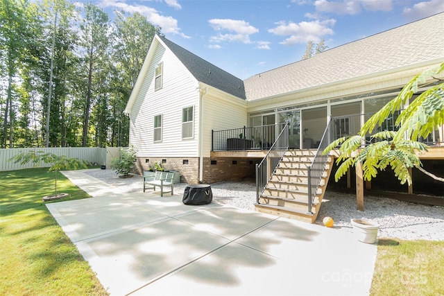 back of house with a shingled roof, a patio, crawl space, stairs, and fence