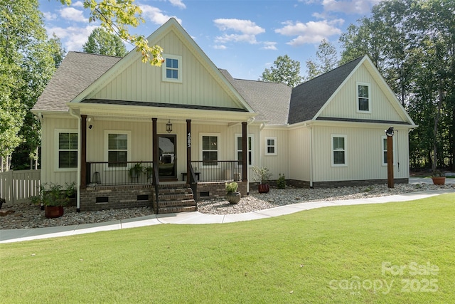 view of front of home featuring roof with shingles, crawl space, covered porch, a front lawn, and board and batten siding