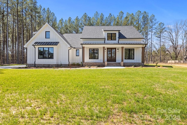 modern inspired farmhouse featuring a front yard and covered porch