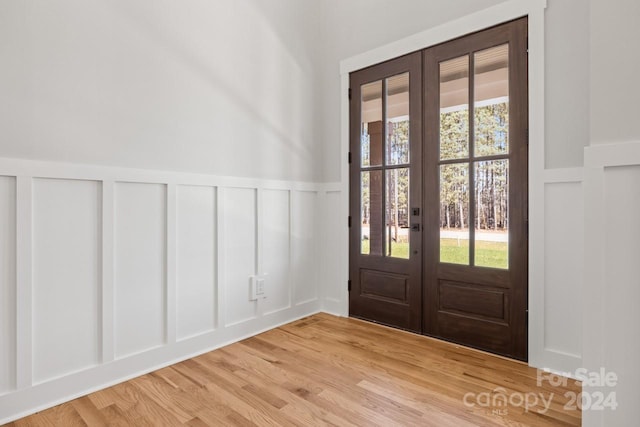 entrance foyer featuring french doors and light hardwood / wood-style floors