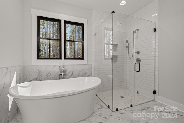 bathroom with tile walls, tile patterned flooring, and plus walk in shower