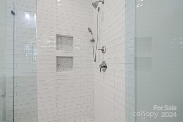 bathroom featuring a shower with door