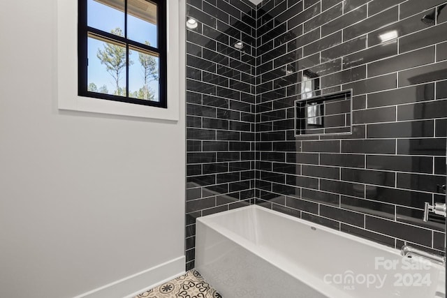 bathroom with tiled shower / bath combo and tile patterned floors