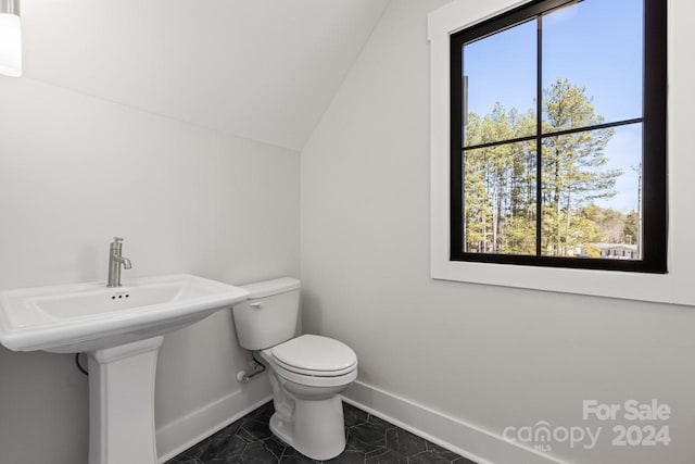 bathroom with toilet, tile patterned floors, and lofted ceiling