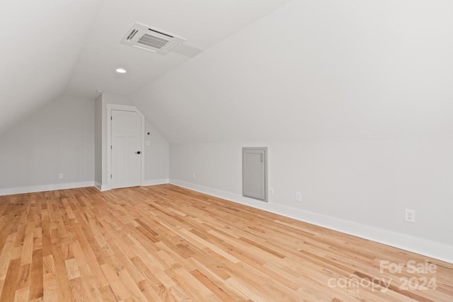 bonus room featuring light wood-type flooring and lofted ceiling