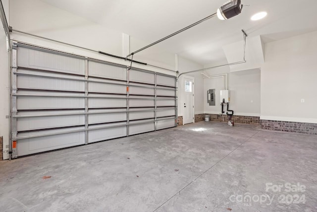 garage with a garage door opener and electric panel