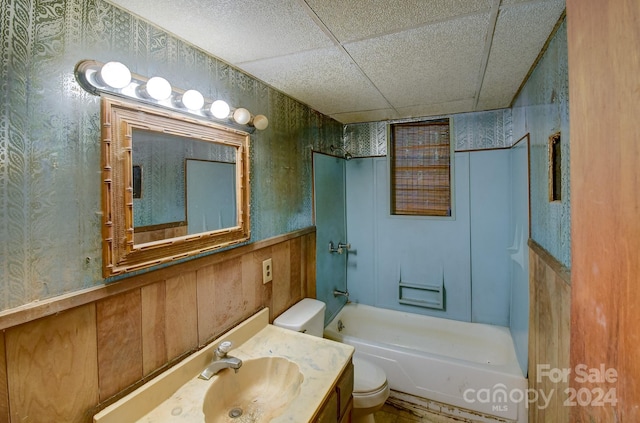 full bath with wallpapered walls, a wainscoted wall, toilet, shower / tub combination, and vanity