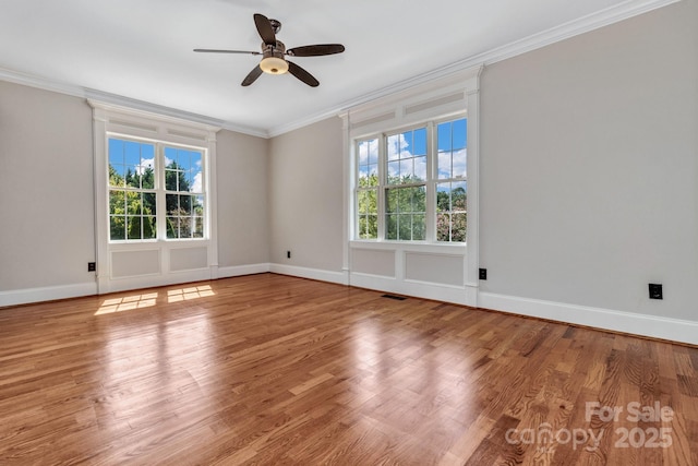 spare room with ornamental molding, wood-type flooring, and ceiling fan