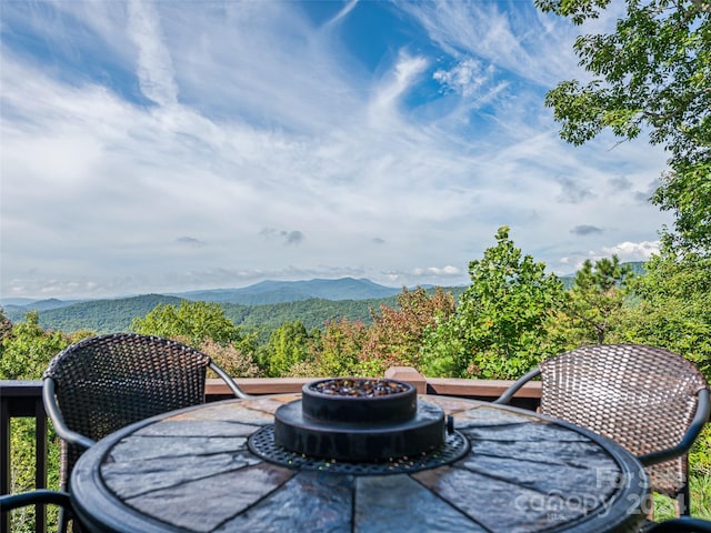 view of patio with a fire pit and a mountain view