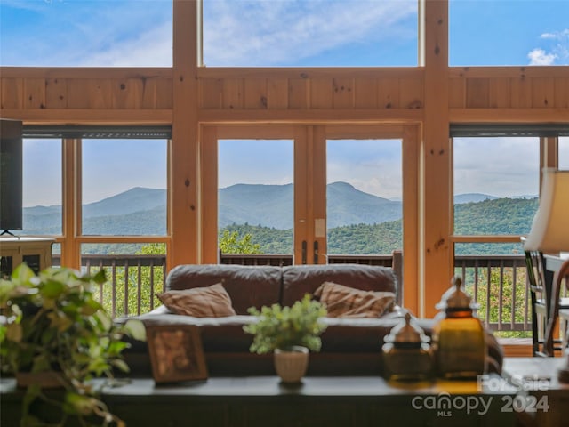 sunroom featuring a mountain view and a wealth of natural light