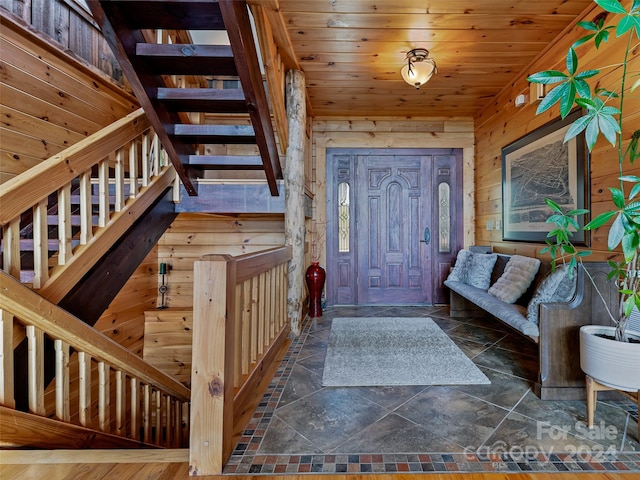 entryway featuring wood ceiling and wood walls