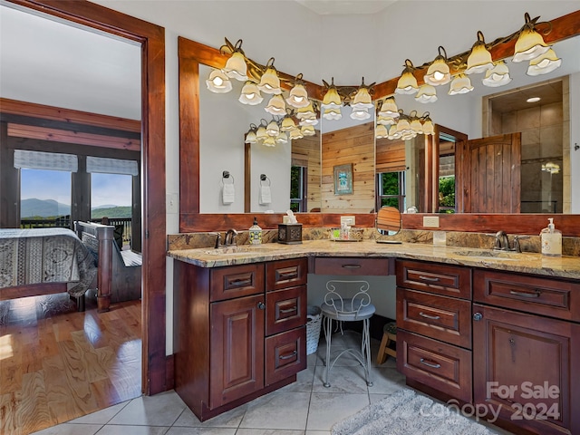 bathroom featuring vanity, plenty of natural light, hardwood / wood-style flooring, and a shower