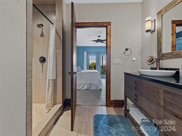 bathroom featuring vanity, hardwood / wood-style flooring, ceiling fan, french doors, and a shower with curtain