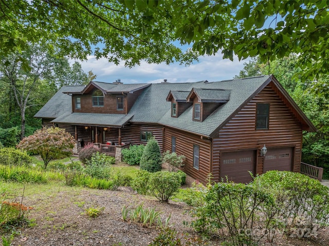 log-style house with a garage