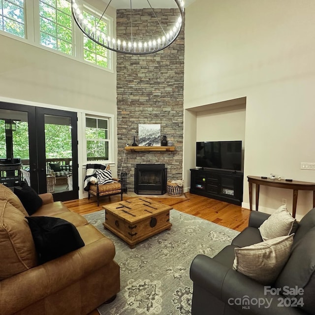 living room featuring a fireplace, hardwood / wood-style flooring, and a high ceiling