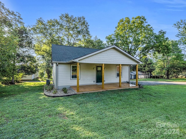 view of front of property with a porch and a front lawn