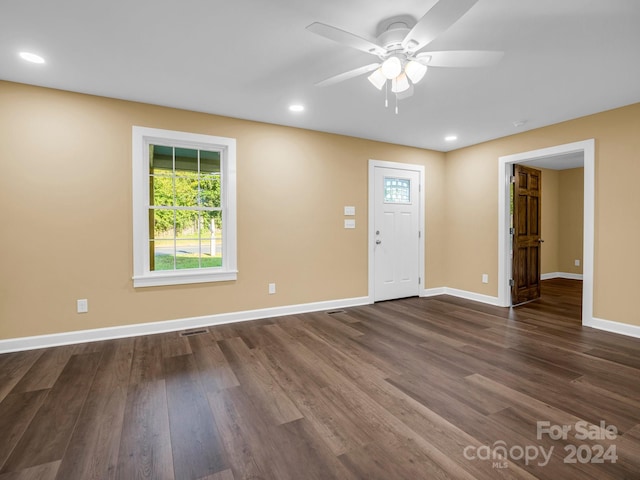 unfurnished room featuring ceiling fan and dark hardwood / wood-style flooring