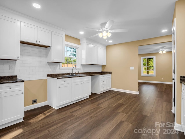 kitchen featuring dark wood-type flooring, white cabinets, ceiling fan, and sink