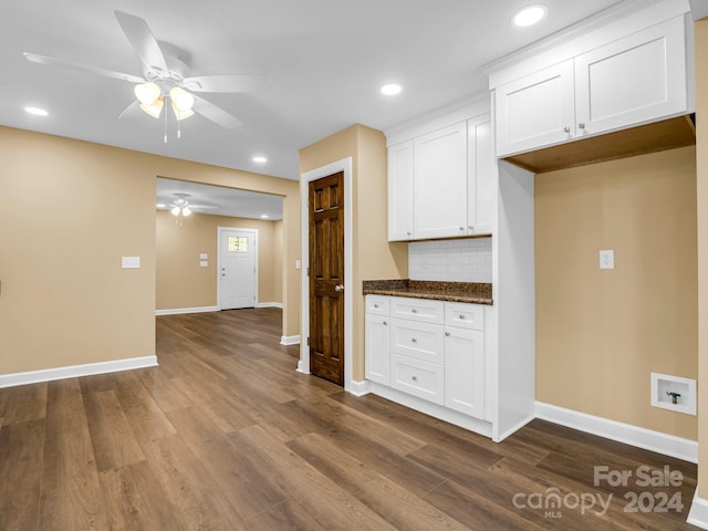 kitchen featuring dark wood-type flooring, white cabinets, ceiling fan, and decorative backsplash