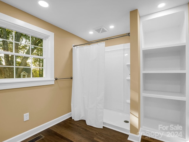 bathroom featuring a shower with shower curtain and hardwood / wood-style floors