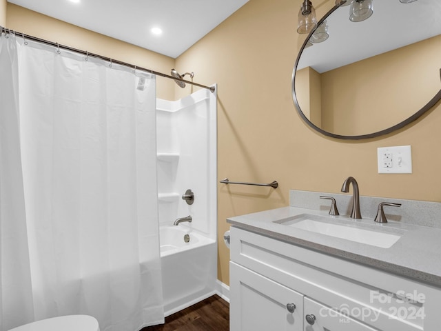 full bathroom with wood-type flooring, toilet, shower / tub combo with curtain, and vanity