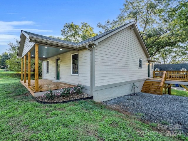 view of property exterior featuring a lawn and a wooden deck