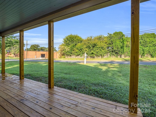 wooden deck featuring a yard