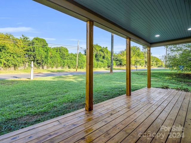 wooden terrace with a lawn