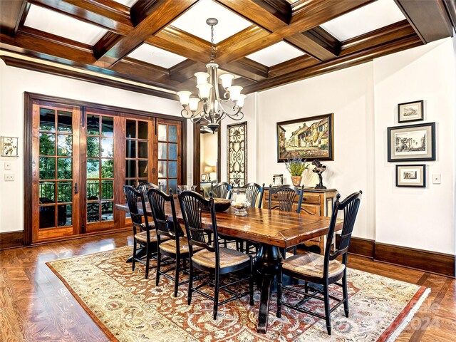 dining room with an inviting chandelier, beamed ceiling, french doors, and coffered ceiling