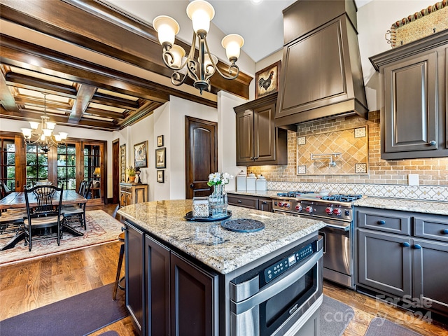 kitchen featuring premium range hood, coffered ceiling, wood-type flooring, beamed ceiling, and stainless steel appliances