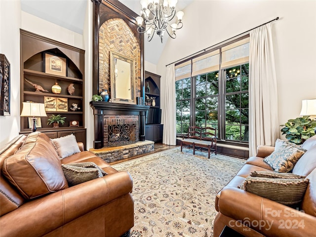 living room with hardwood / wood-style flooring, a chandelier, and built in shelves