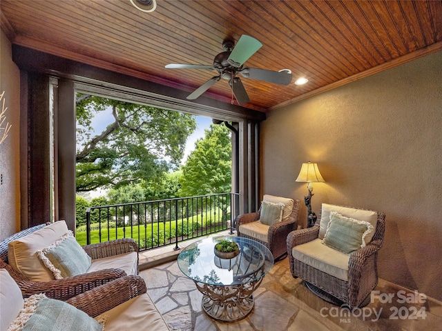 sunroom / solarium with ceiling fan and wooden ceiling