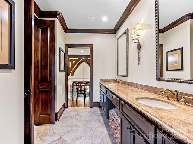 bathroom with hardwood / wood-style floors, ornamental molding, and vanity