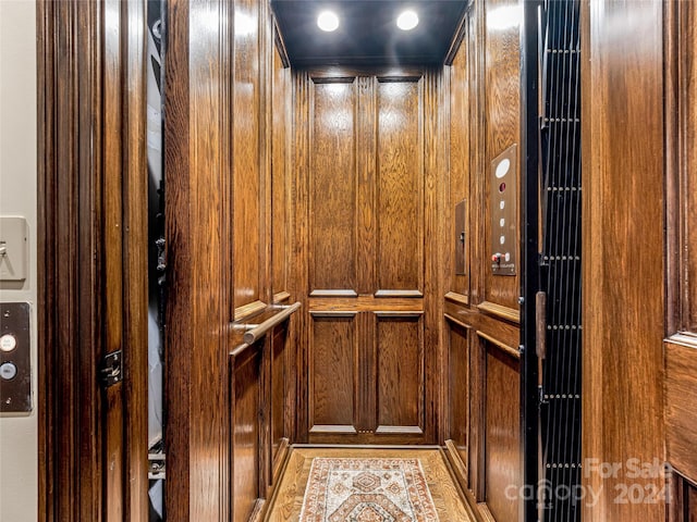 details with wooden walls and elevator