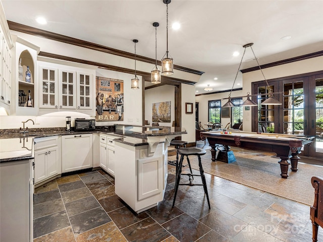 kitchen featuring a kitchen breakfast bar, decorative light fixtures, dark tile patterned floors, billiards, and white cabinets