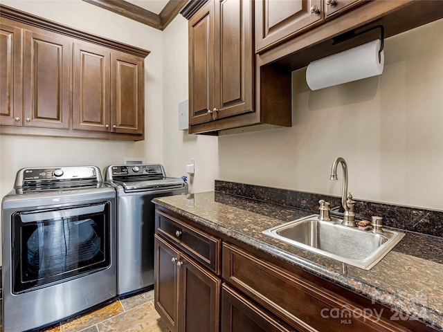 laundry area featuring cabinets, independent washer and dryer, light tile patterned floors, sink, and crown molding