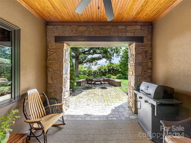 view of patio featuring ceiling fan and an outdoor kitchen