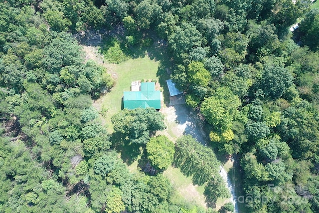 bird's eye view featuring a wooded view