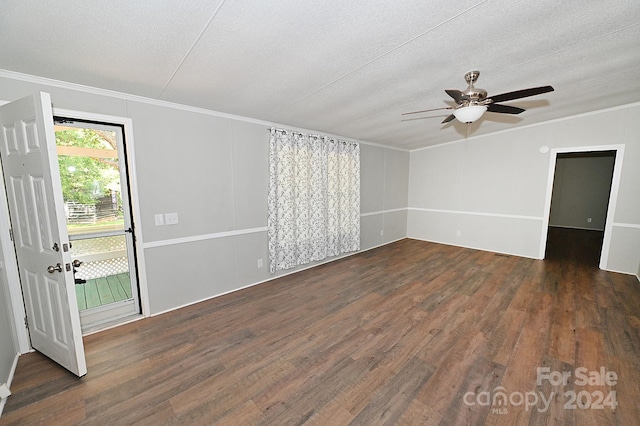 empty room featuring ornamental molding, a textured ceiling, and wood finished floors