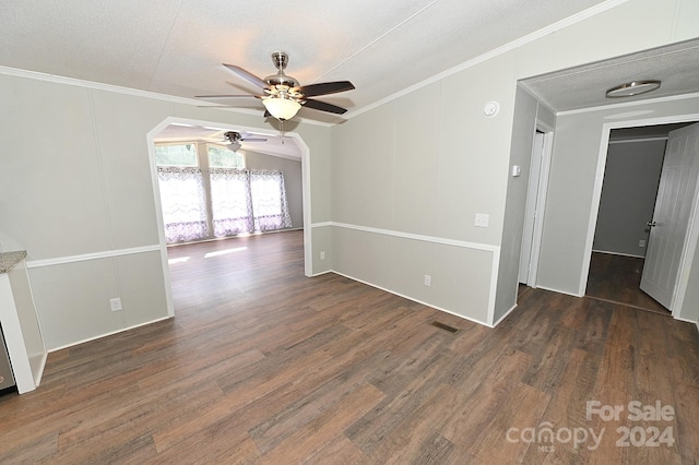 spare room with ornamental molding, wood finished floors, and visible vents