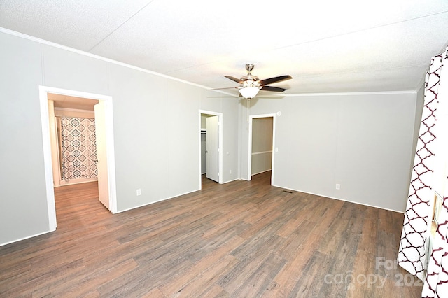 unfurnished room with a ceiling fan, ornamental molding, and wood finished floors