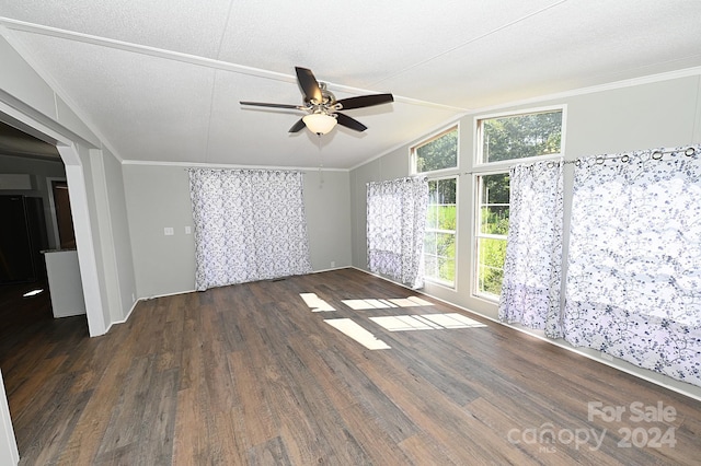 spare room featuring crown molding, lofted ceiling, a ceiling fan, a textured ceiling, and wood finished floors