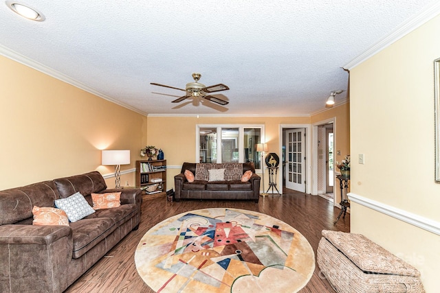 living room with a textured ceiling, ceiling fan, hardwood / wood-style flooring, and crown molding