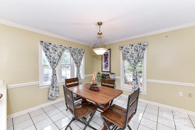 dining space featuring a textured ceiling, crown molding, and plenty of natural light