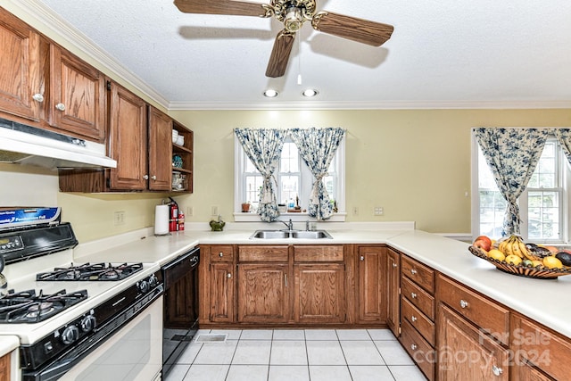 kitchen with light tile patterned flooring, gas range gas stove, ceiling fan, ornamental molding, and sink