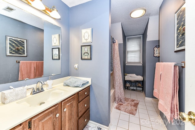 bathroom with shower / bathtub combination with curtain, tile patterned flooring, a textured ceiling, and vanity