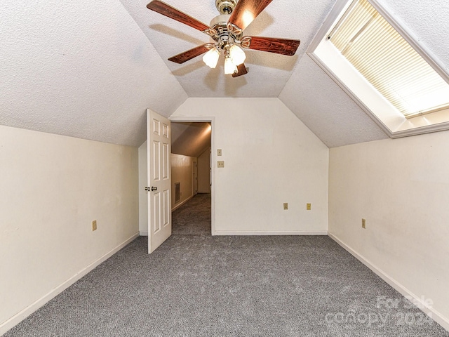 bonus room with carpet, lofted ceiling, a textured ceiling, and ceiling fan